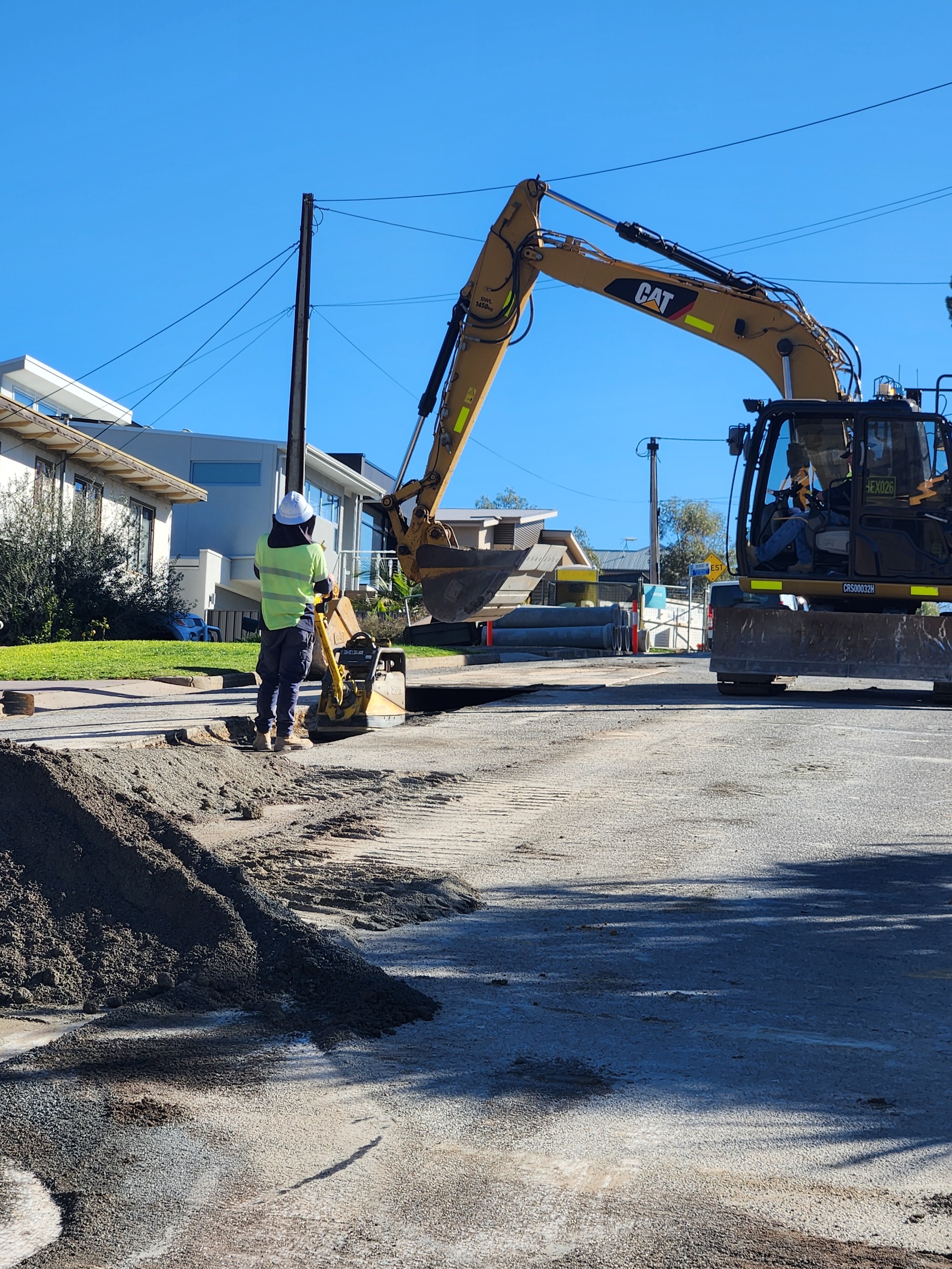 Drainage works underway on Murray Road, with excavator and crew.