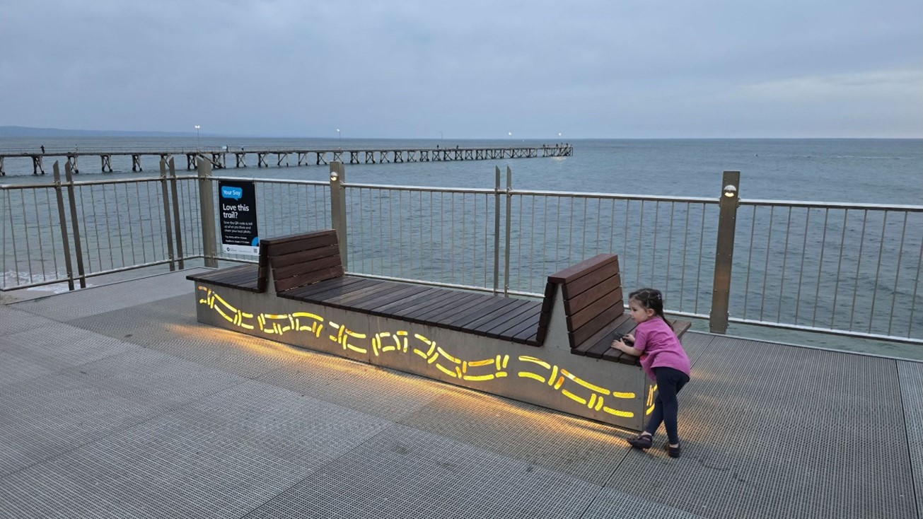 Image of seat on trail with girl